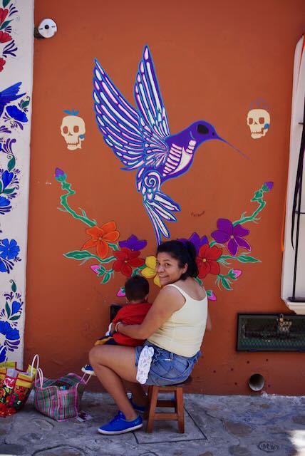 Oaxaca Mural Art, mom holding baby while painting!